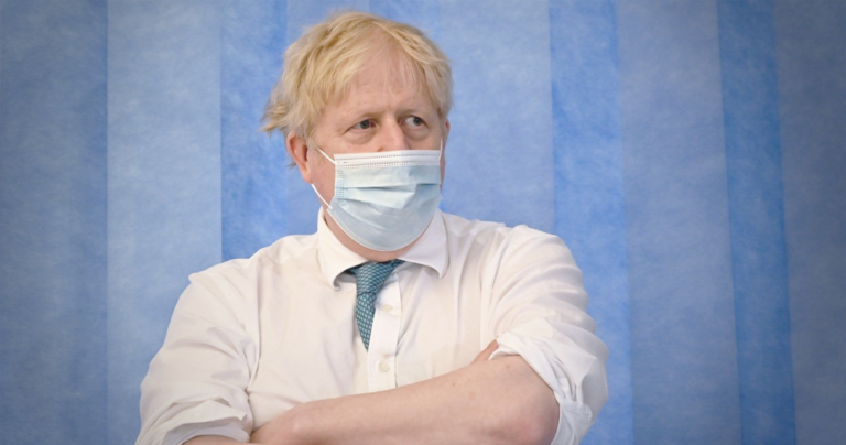 UK PM Boris Johnson wearing a face mask PPE in an NHS hospital
